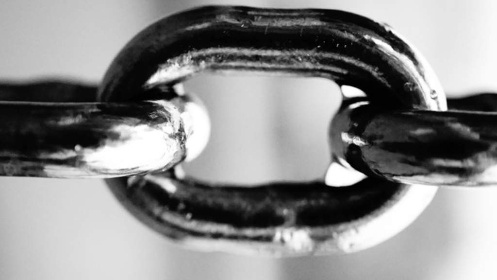 Close up of three links of a heavy chain